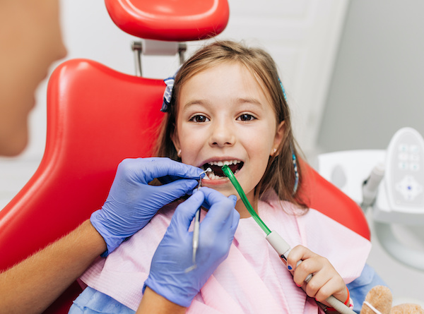 Kids Dentistry | Cute little girl sitting in Children's Dentist chair having dental treatment
